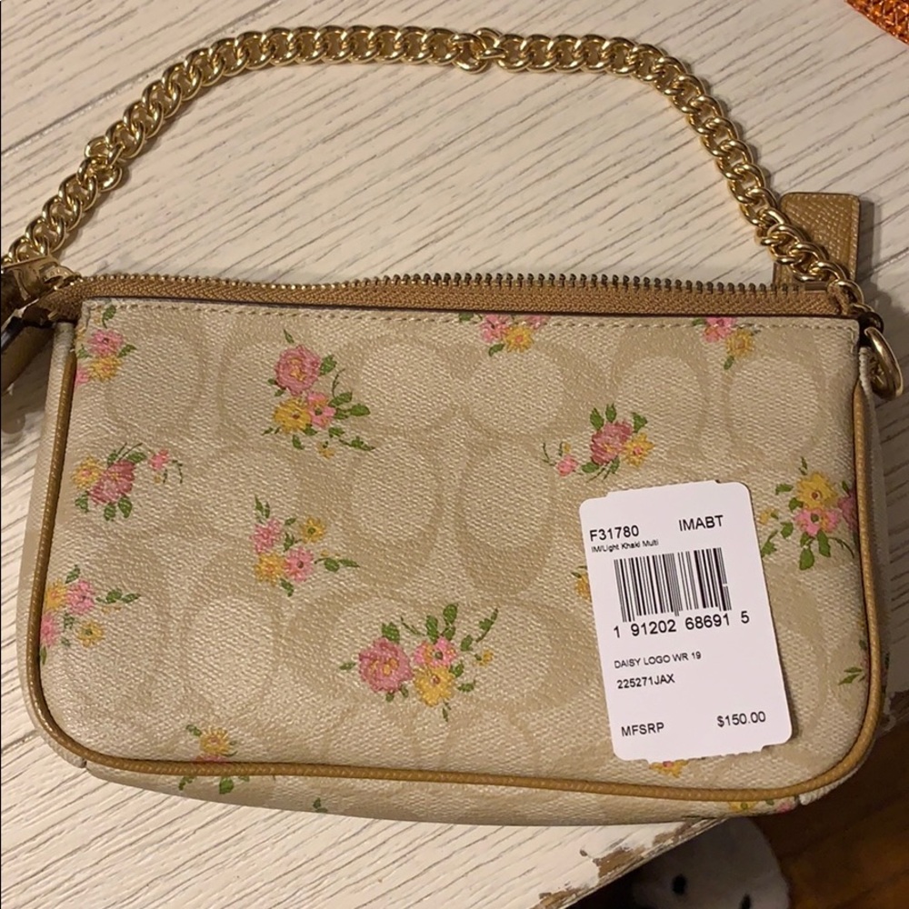 Coach floral large wristlet with chain strap.